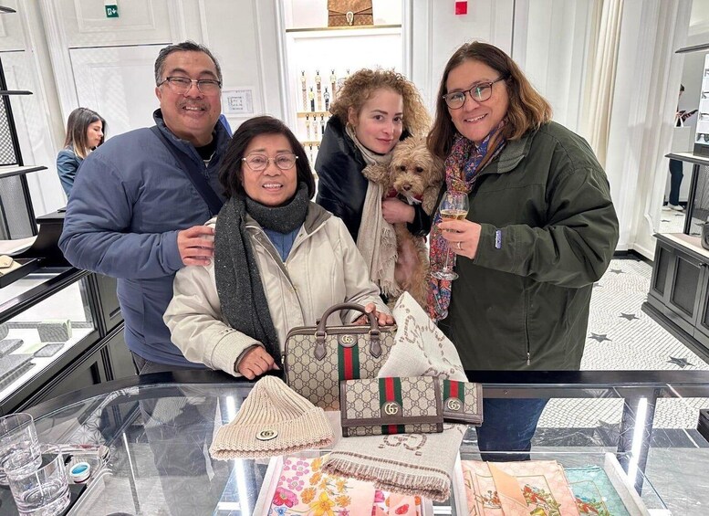 A group of people in a jewelry store with handbags and accessories on display. 5