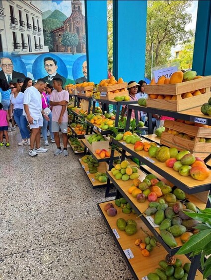 A fruit market with various fruits displayed on wooden crates. 4