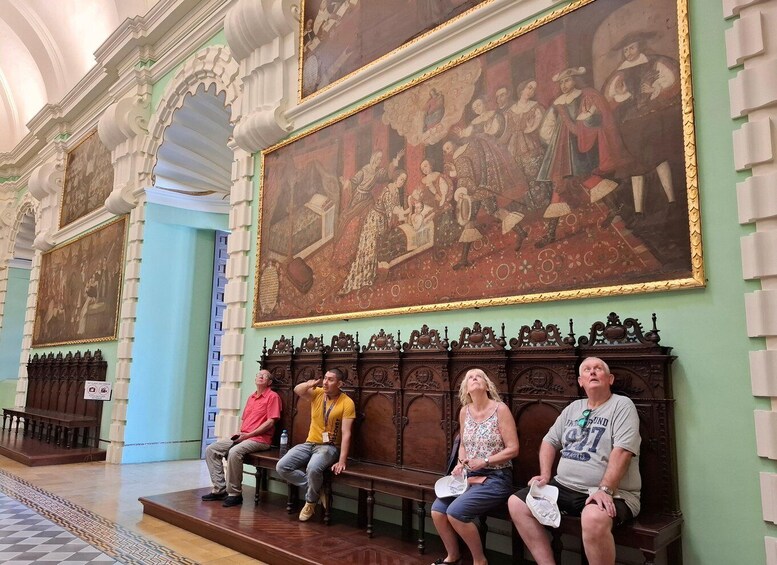 A historic building with ornate columns and large paintings. 2