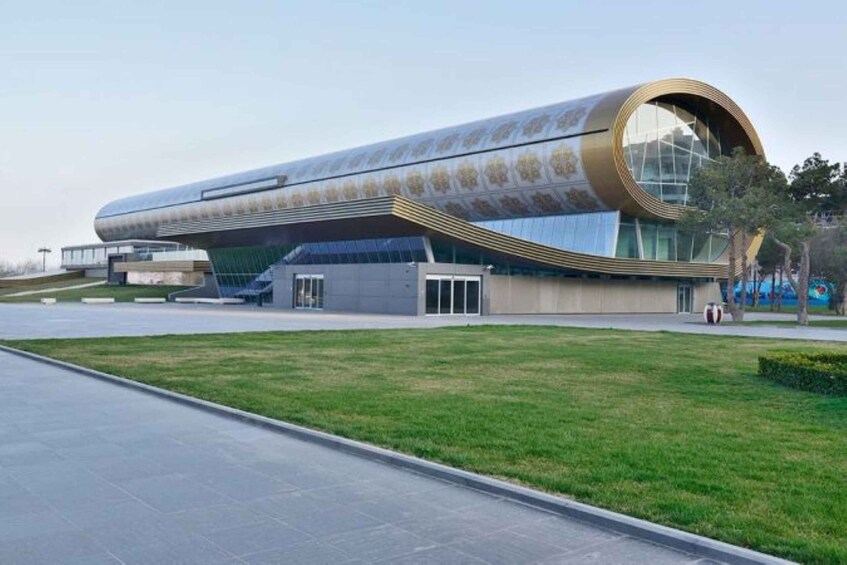 A modern building with a curved glass facade and a cylindrical section. 3