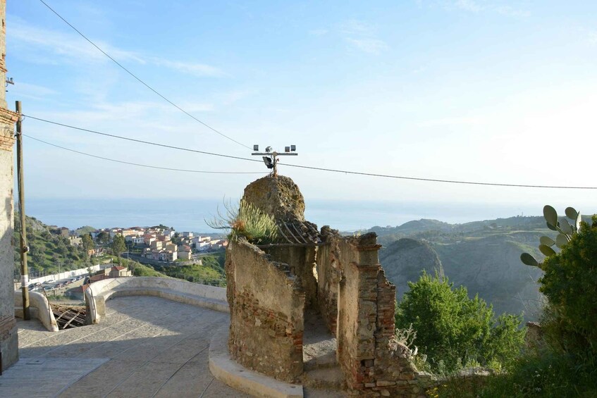 A coastal town with a stone structure and a power line. 2