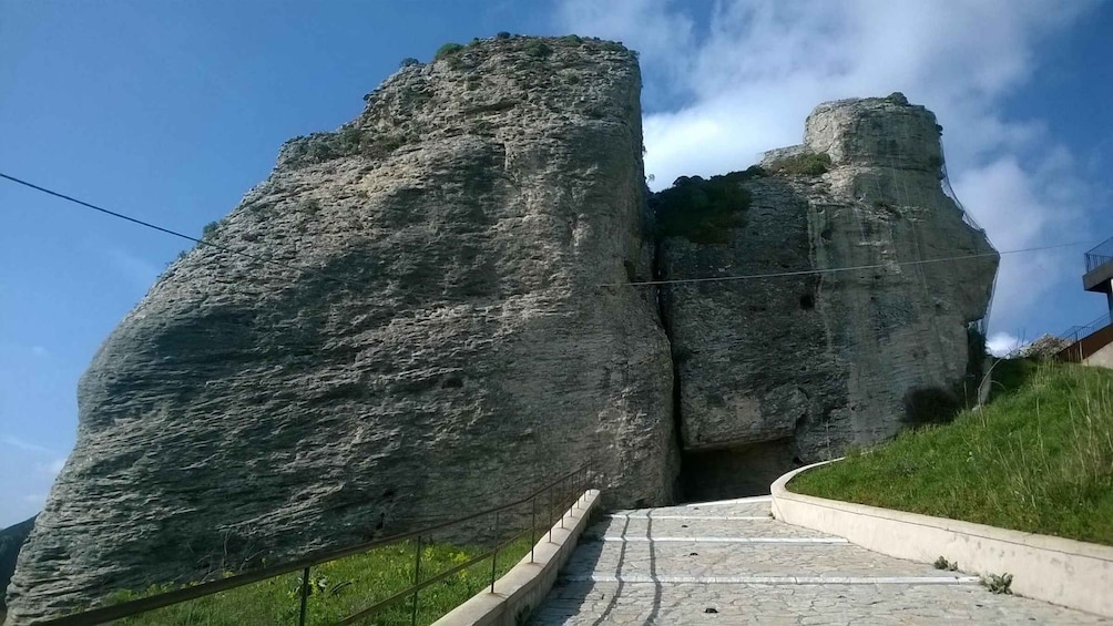 A large rock formation with a staircase leading up to it. 4