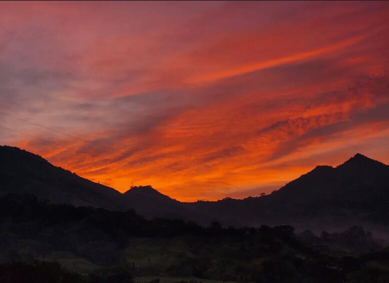 A sunset over a mountainous landscape with a vibrant sky. 3