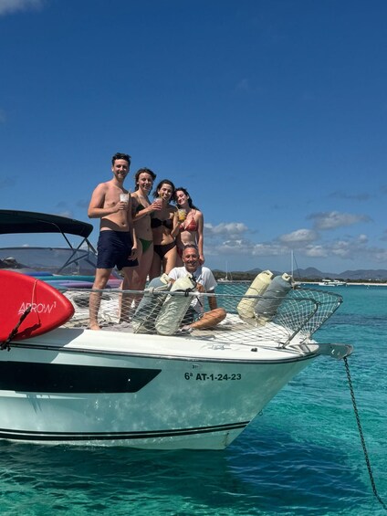 A group of people on a boat with a clear blue sky and calm sea in the background. 2