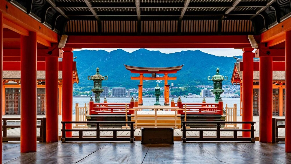 A traditional Japanese torii gate with a mountain backdrop. 5