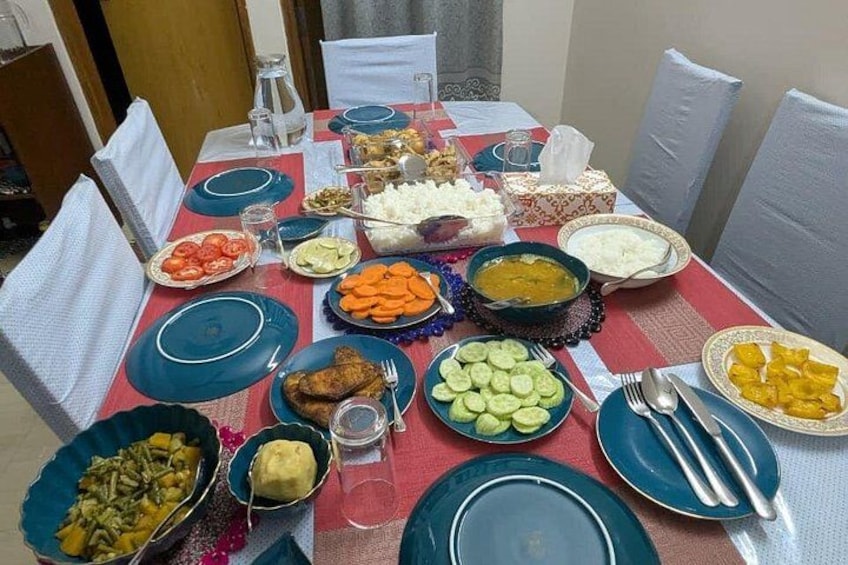 A table set with various dishes, including rice, vegetables, and meat. 4