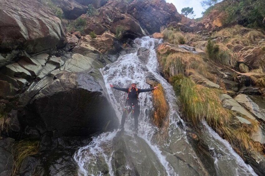 A person standing in a rocky stream with water flowing over rocks. 3