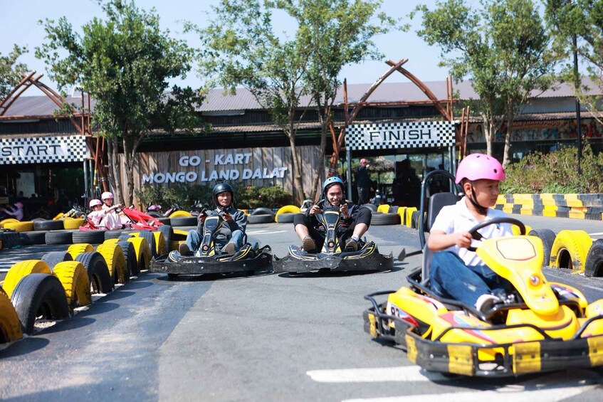 Go-karts on a track with a finish line and a sign that reads 'GO-KART MONGO LAND DALAT'. 2