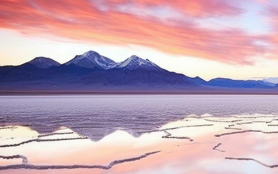 A salt flat with mountains in the background. 1