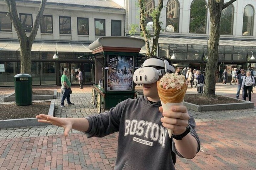 A person holding an ice cream cone in Boston. 5