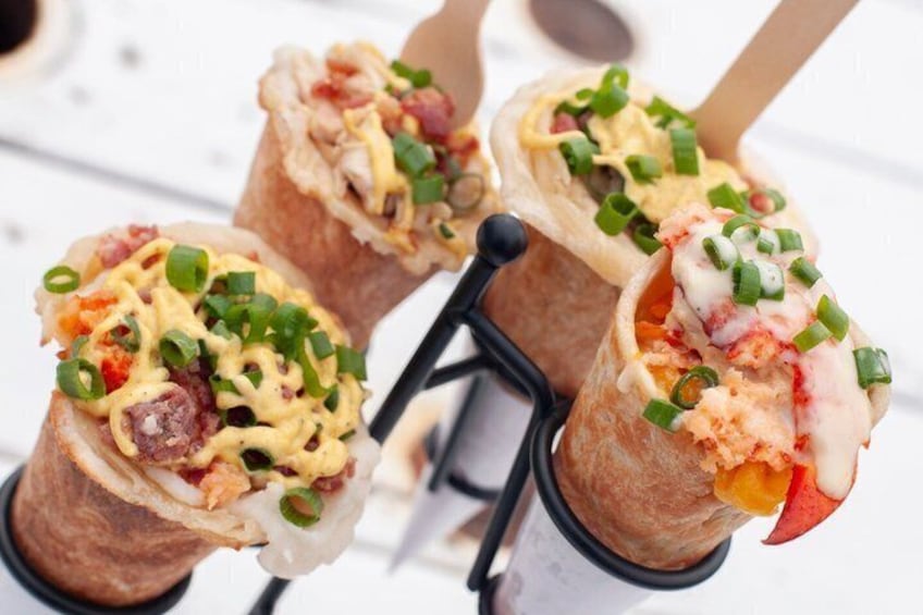 A food stall with tacos on skewers. 1