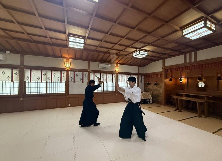 A traditional martial arts training room with tatami flooring, wooden beams, and shoji screens. 5