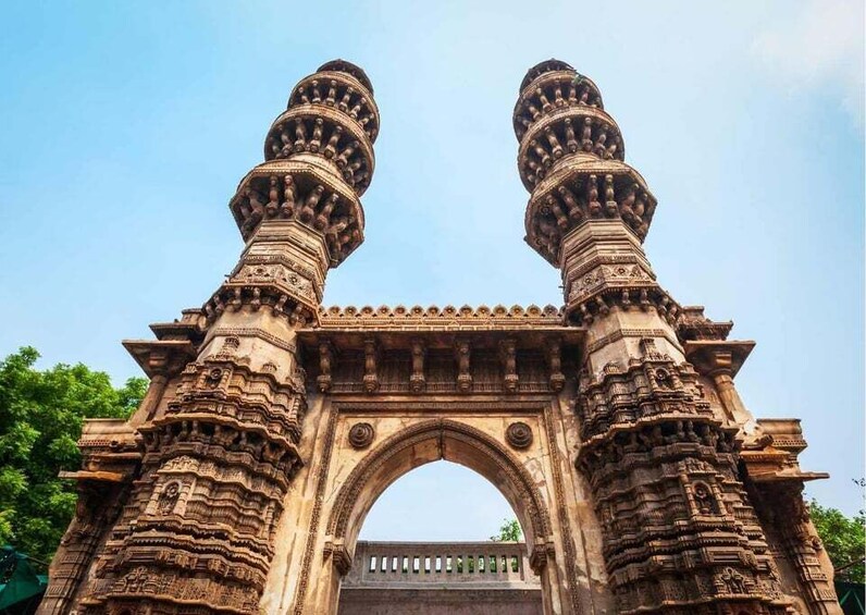 A stone gateway with intricate carvings and two symmetrical towers. 5
