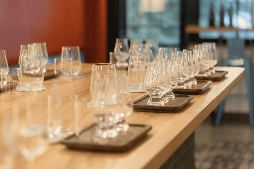 A row of empty wine glasses on a wooden table. 4