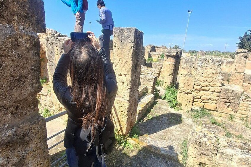 A person taking a photo of ancient ruins with a smartphone. 3