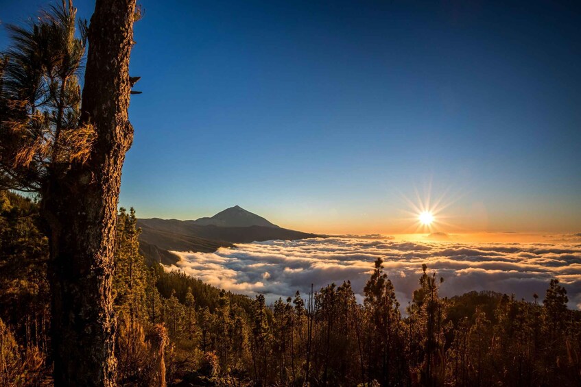 A mountain at sunrise with clouds below. 2