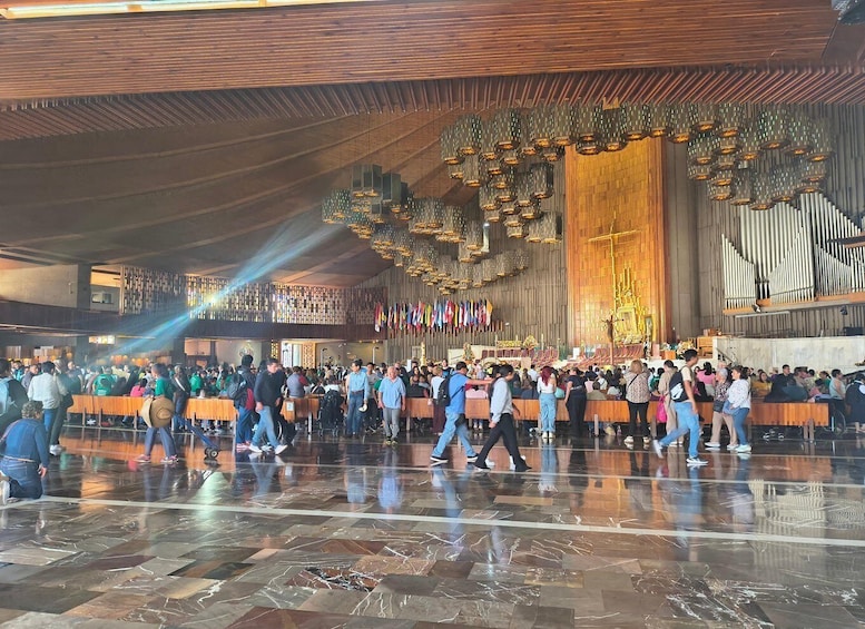 A large indoor gathering with a prominent organ and flags. 4
