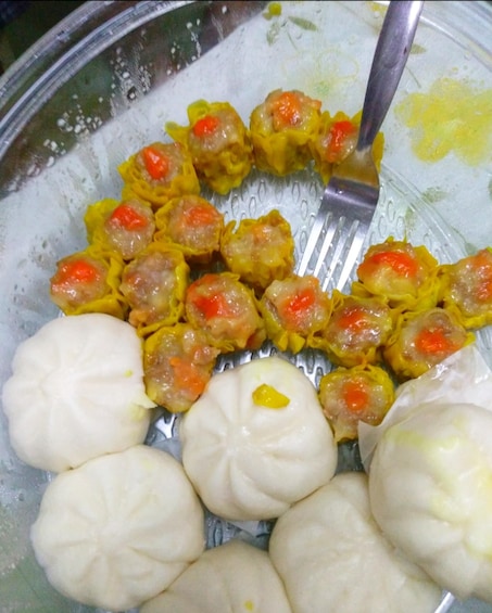 A plate of dumplings, some with red filling and others with a white filling. 3