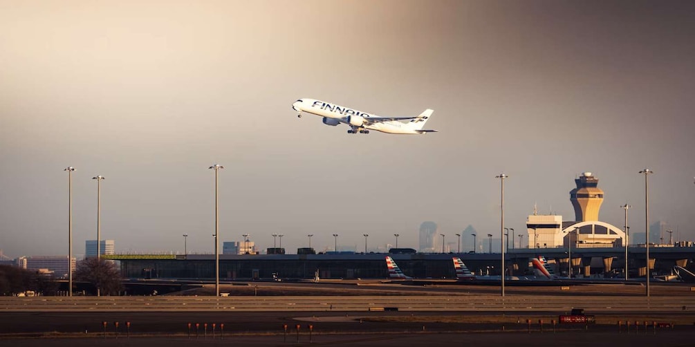 An airplane labeled 'FINNAIR' approaching for landing at an airport. 4