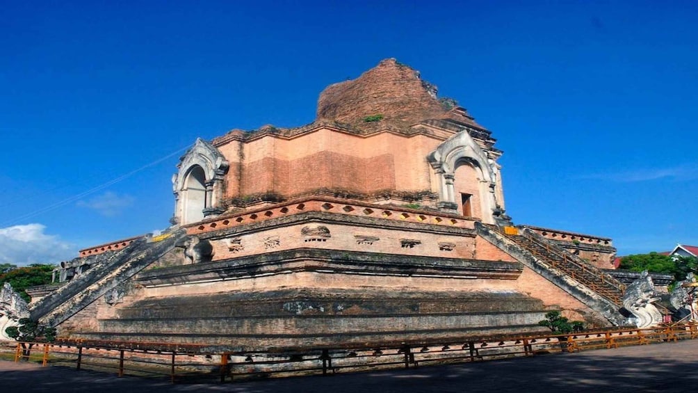 A large, ancient temple with a stepped pyramid structure and ornate carvings. 1