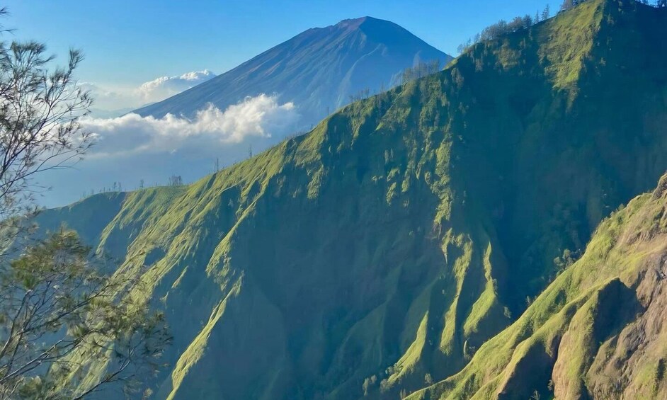 A mountain with a cloud-covered peak and lush green slopes. 5