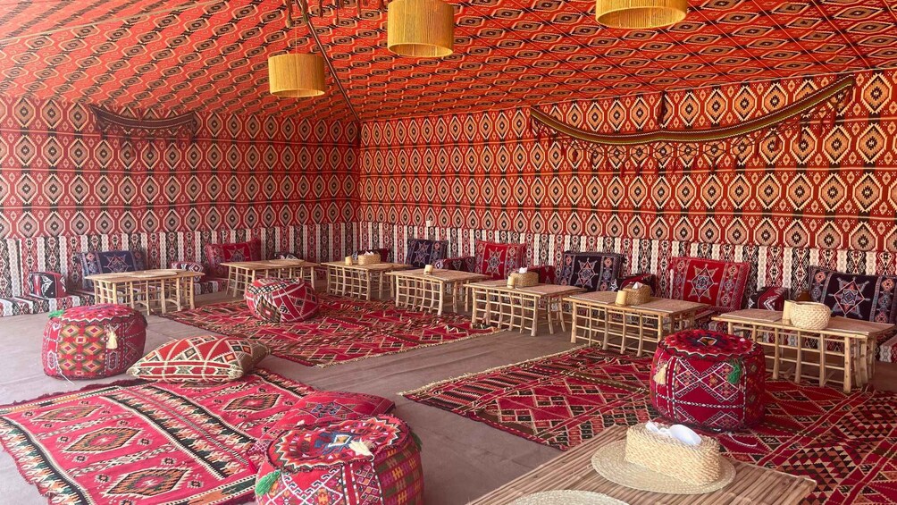 A traditional setting with patterned walls, wooden furniture, and red carpets. 3