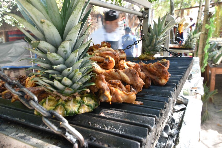 Grilled chicken and pineapples on a barbecue grill. 5