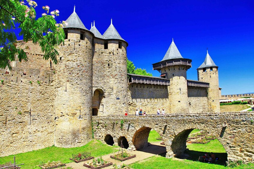 A historic stone castle with multiple towers and a bridge. 2