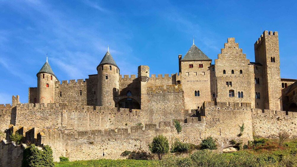 A medieval castle with multiple towers and a large stone wall. 5