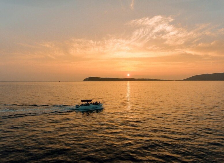 A boat on calm water during sunset with a clear sky. 5