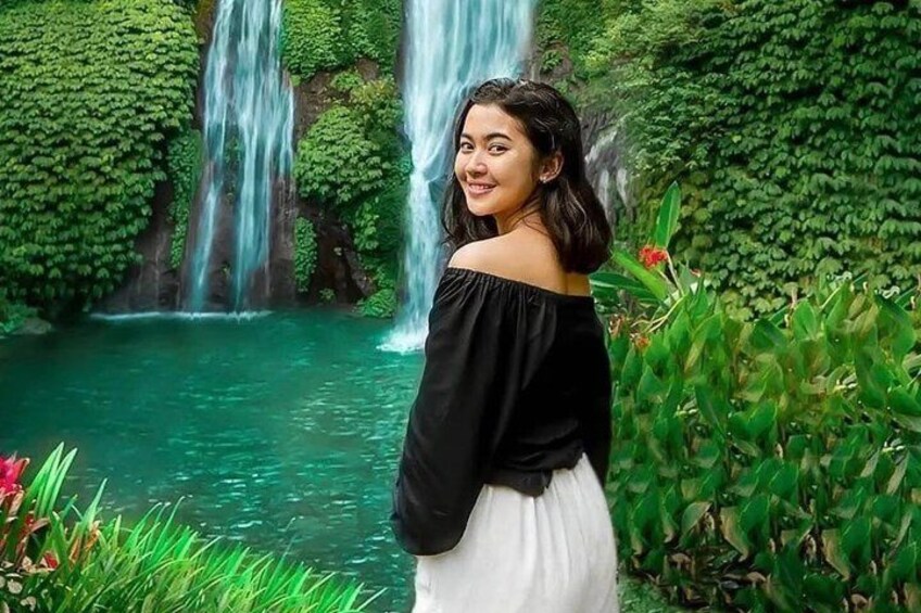 A waterfall surrounded by lush greenery. 2