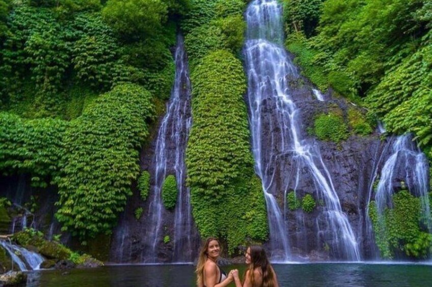 A waterfall surrounded by lush greenery. 3