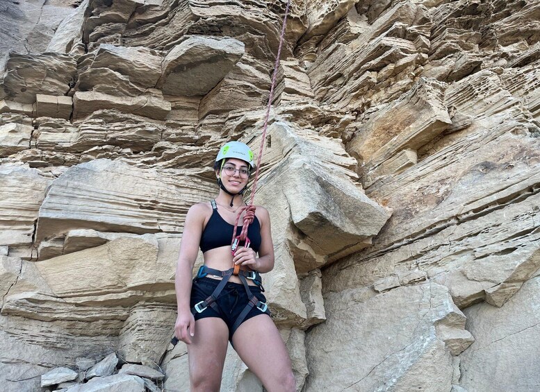 A person rock climbing against a rocky cliff. 5
