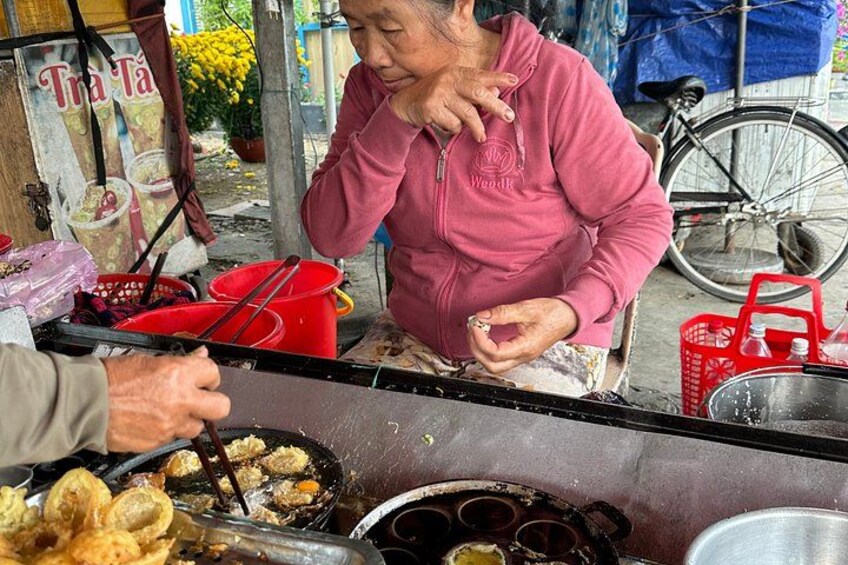 A street food vendor preparing food at a stall. 4