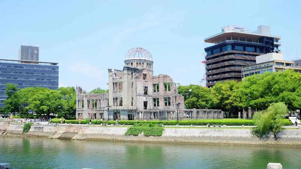 A historic building with a dome, surrounded by modern skyscrapers and a river. 3
