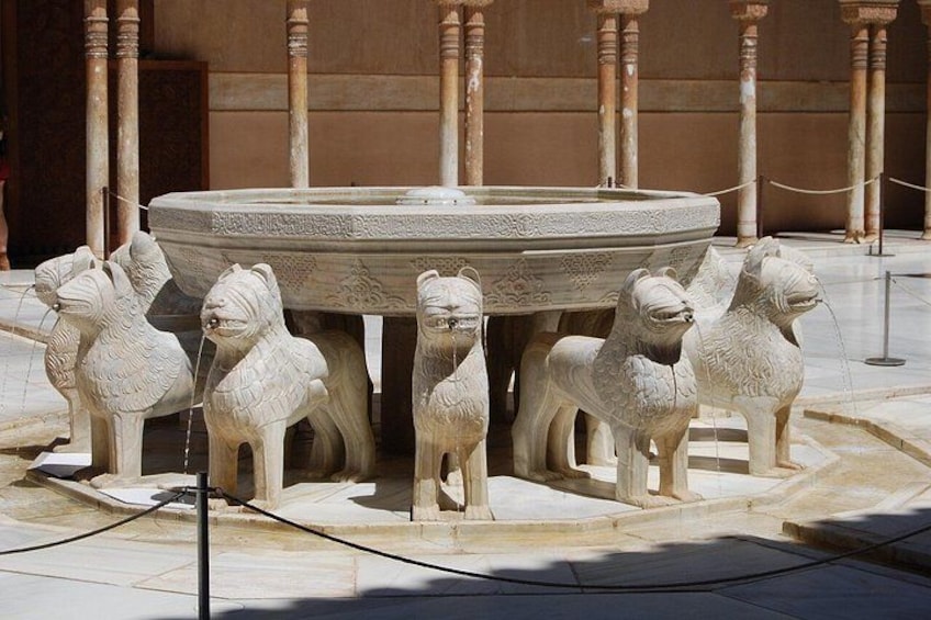A marble fountain with horse statues and a circular basin. 5