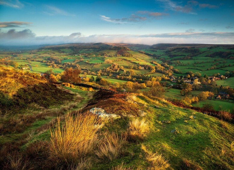 Rolling hills, a winding river, and scattered houses in a rural landscape. 5