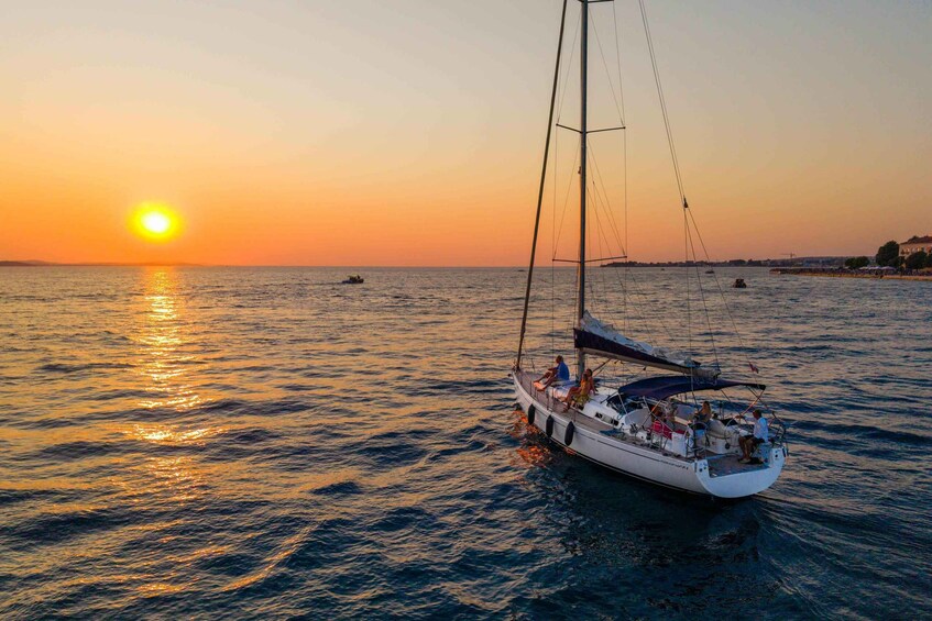 A sailboat on calm waters during sunset. 1