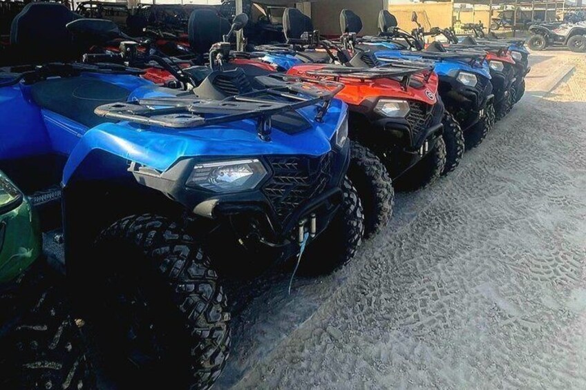 Une rangée de quads est stationnée sur une surface sablonneuse. 3