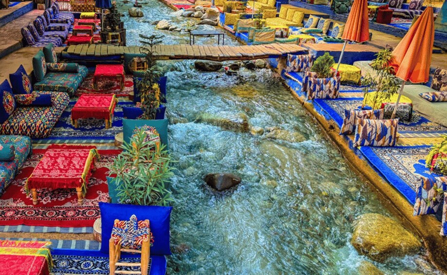 A riverside seating area with colorful rugs and sofas. 5