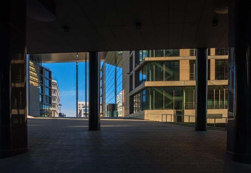An open plaza with modern buildings and large glass windows. 2