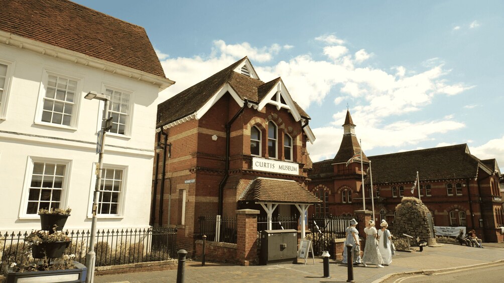 A historic building labeled 'CURTIS MUSEUM' with a traditional brick facade and a prominent tower. 2