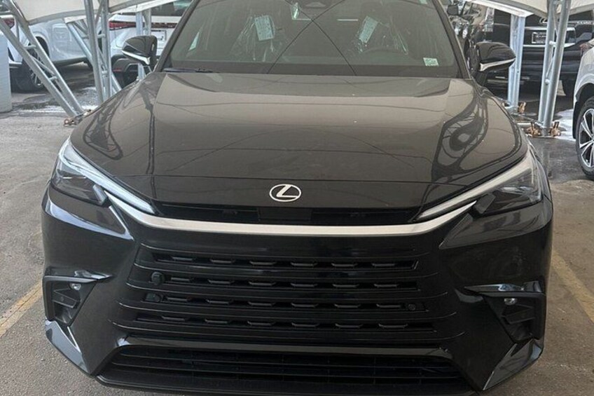 A black Lexus SUV parked in a lot with other vehicles. 2