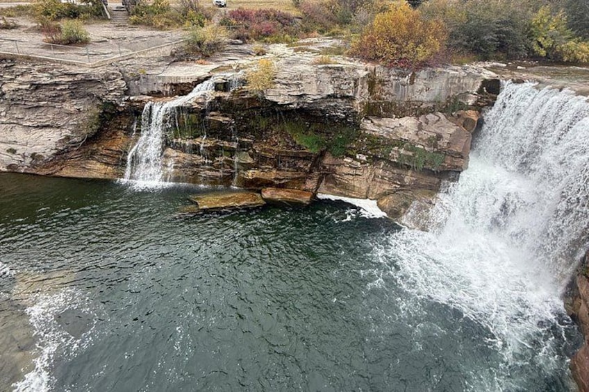A waterfall cascading over rocky terrain into a calm pool of water. 3