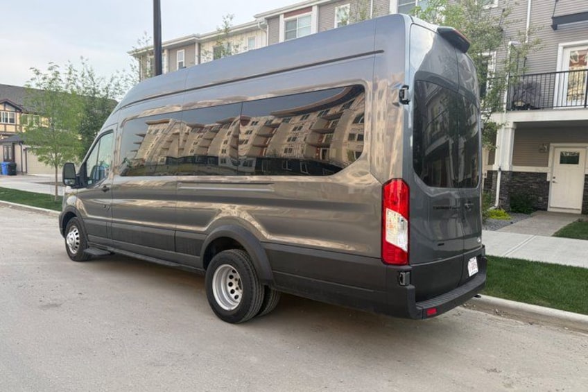 A gray van parked on a residential street. 2