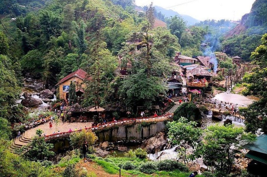 A mountainous village with a river, bridges, and traditional buildings. 4