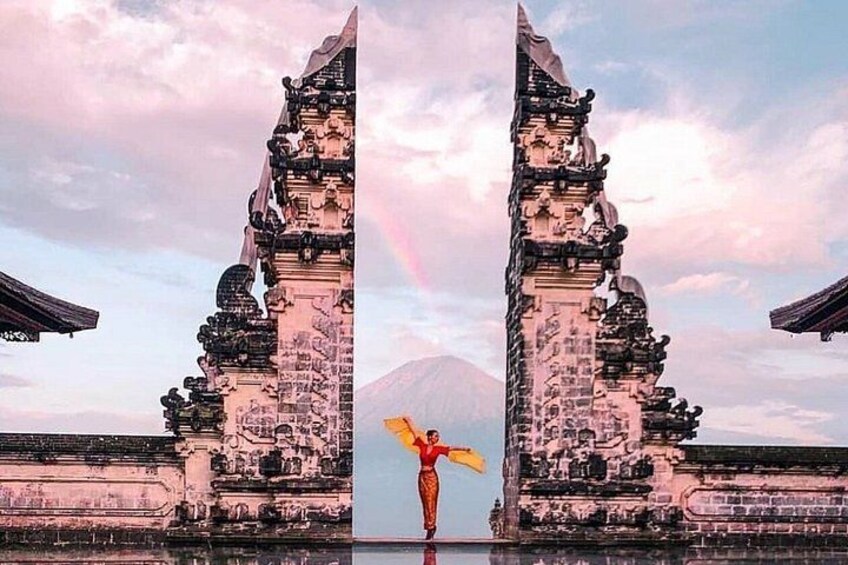 A temple with intricate carvings and a rainbow in the background. 1