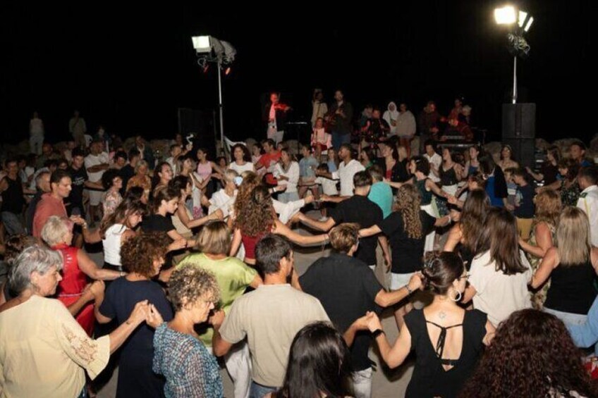 A large crowd dancing at an outdoor event. 2