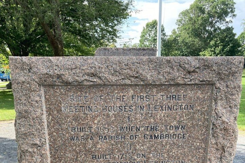 A granite monument with inscriptions about the first three meeting houses in Lexington, built in 1692 and 1693 when the town was a parish of Cambridge. 4