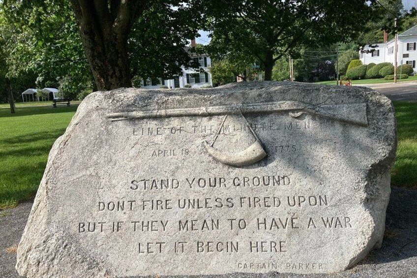 A stone monument with an engraved eye and text. 3